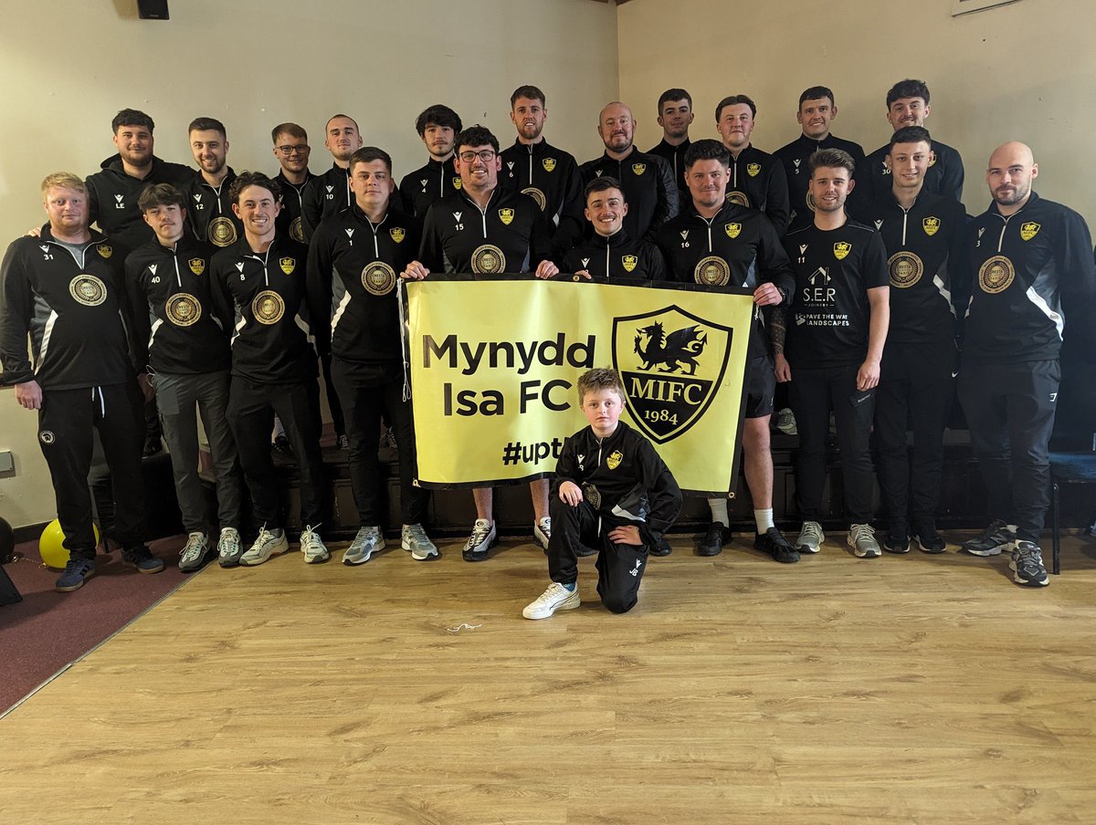 Isafootballclub's tweet photo. Here come the champions! 

Introducing the winners of the  @WalesEast Mike Beech Trophy 23/24 - @MynyddIsaFC. 

What a game, what a result, cheered on by a 350+ crowd. 

Congratulations to each player who stepped out on to that pitch today. 

What a feeling. 
This is football. https://t.co/7dKtmH6QvY
