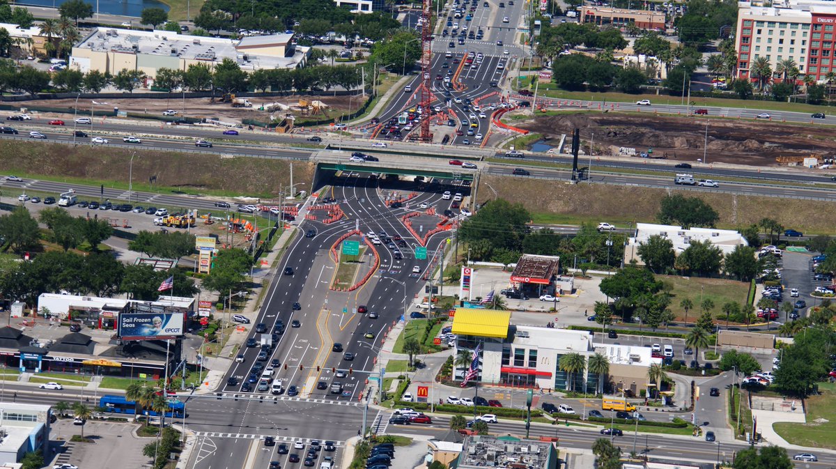 Aerial photo of the redo of the Sand Lake Rd and I-4 Interchange. Recently changed to Diverging Diamond pattern so that a crane can work in the median to build the new overpasses. 📸Apr 12