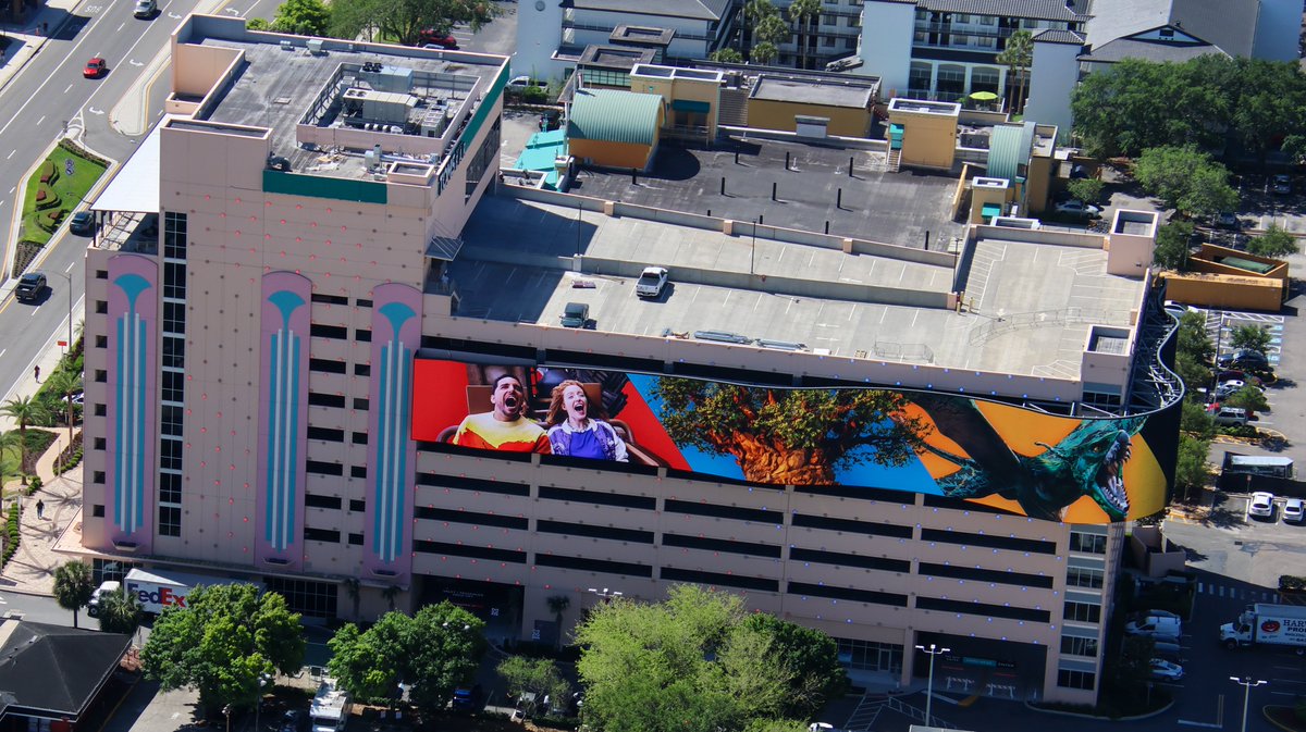 Aerial photo of the Walt Disney World flowing video ribbon on the Hollywood Plaza parking garage. Seen here with scenes from Animal Kingdom.