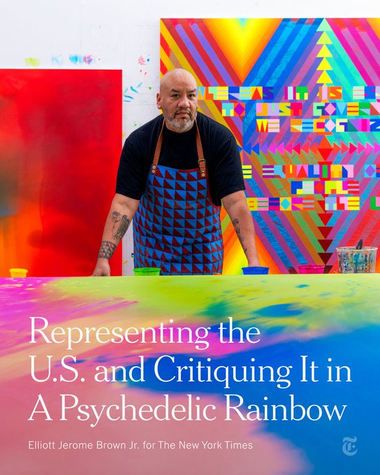 Jeffrey Gibson wearing an apron in front of brightly colored and patterned artwork. A headline reads: Representing the U.S. and Critiquing It in A Psychedelic Rainbow. Photo by Elliott Jerome Brown Jr. for The New York Times