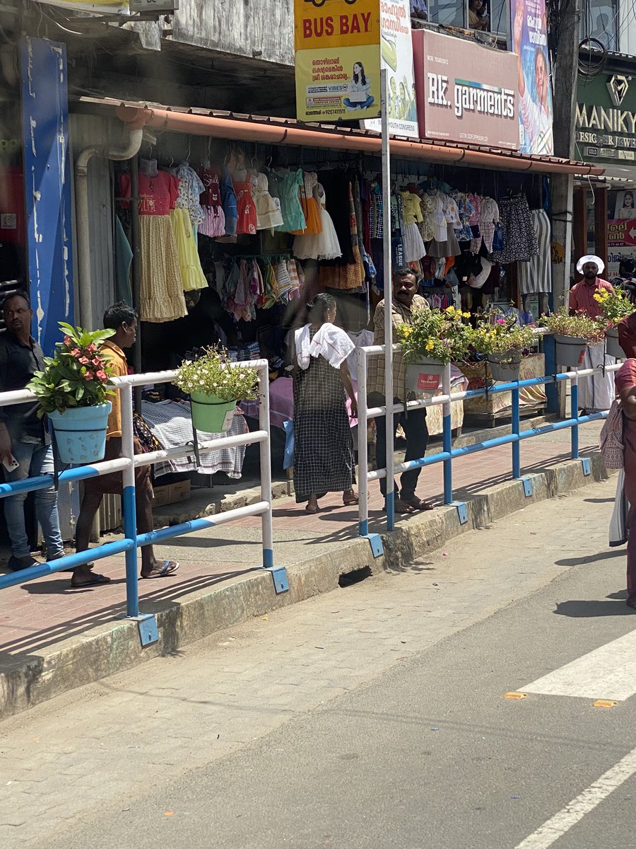 I love how the footpath at Wayanad has flowerpots  like this.