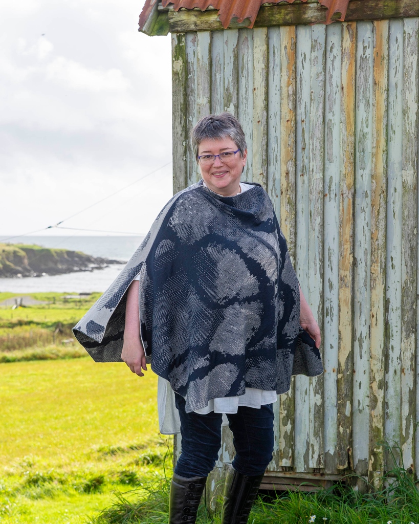 Helen, in Hoswick.⁠ ⁠ Our long Rani cape has a beautiful drape and there is a lovely, subtle sheen to the finely knitted merino yarn.⁠ ⁠ A wearable statement piece.⁠ ⁠ ---⁠ ⁠ Browse: nielanell.com/collections/ra…