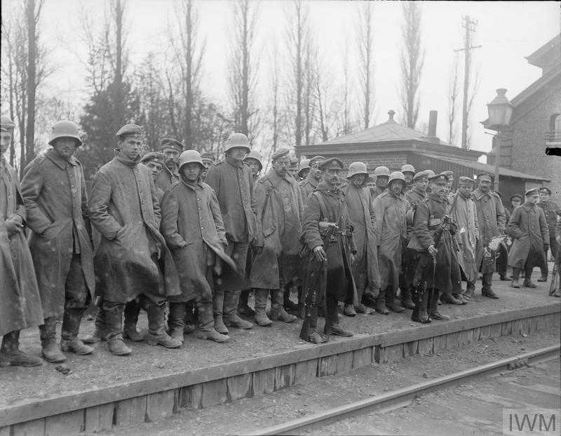 German prisoners on the station platform at Caestre awaiting to be entrained, 15 April 1918.© IWM (Q 10935)