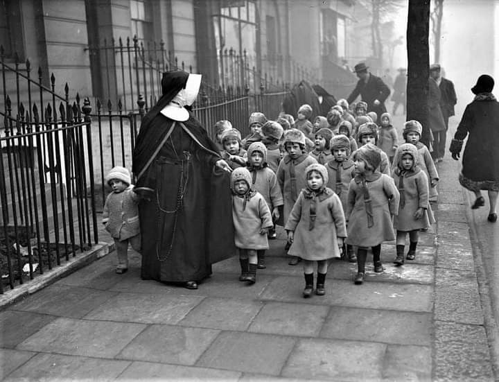 'A nun from Margaret House, Hammersmith, London with a group of orphans in their winter coats in 1929'