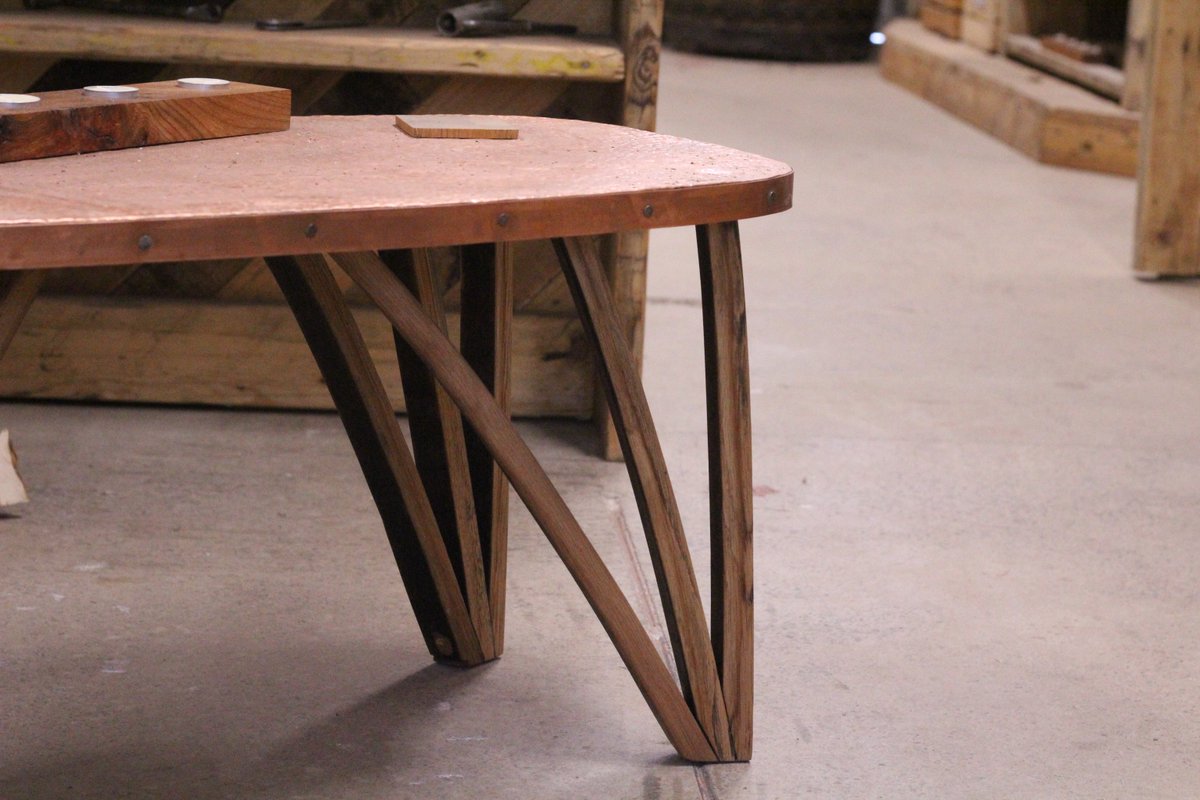 Upcycled vintage copper top pub table with whiskey barrel stave legs, built and upcycled by Development Worker Freya for a wonderful coffee table ☕ Think of the beautiful silhouettes created by those curved legs 🌉 Buy online & in-store: ow.ly/JOiY50Rc7z7