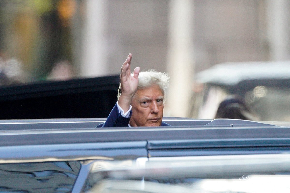 Former President Donald Trump waves as he departs Trump Tower on the first day of his hush money criminal trial. Photo by Eduardo Munoz