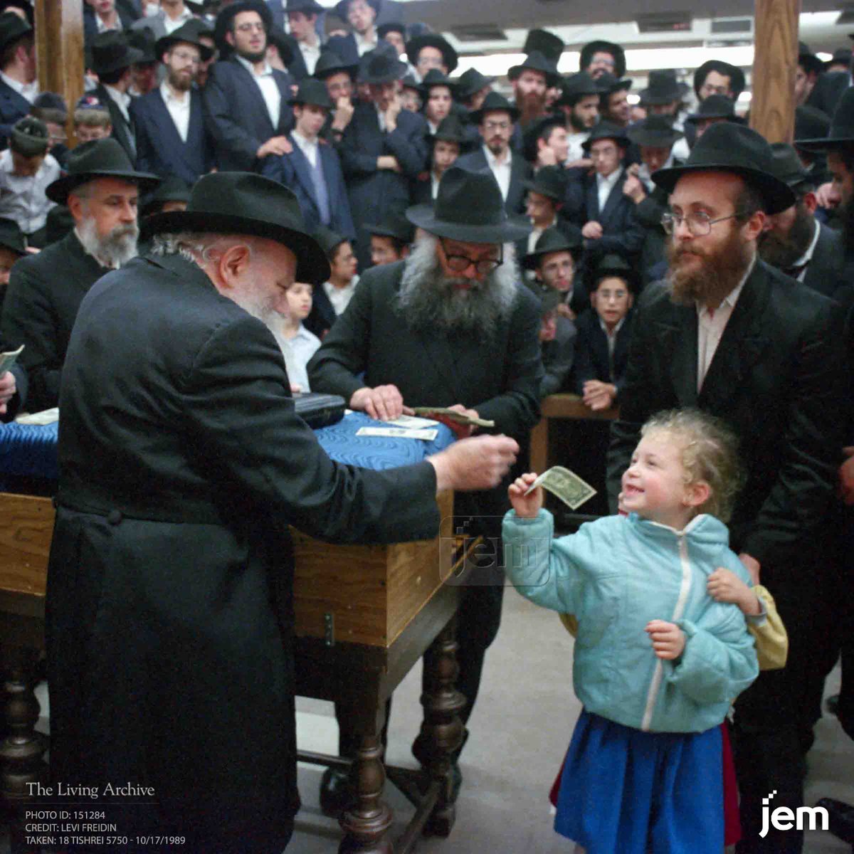 Once, as a young girl received a dollar, she took a photo of the Rebbe. After she turned to leave, the Rebbe called her back, handing her another dollar towards the costs of processing the photo.