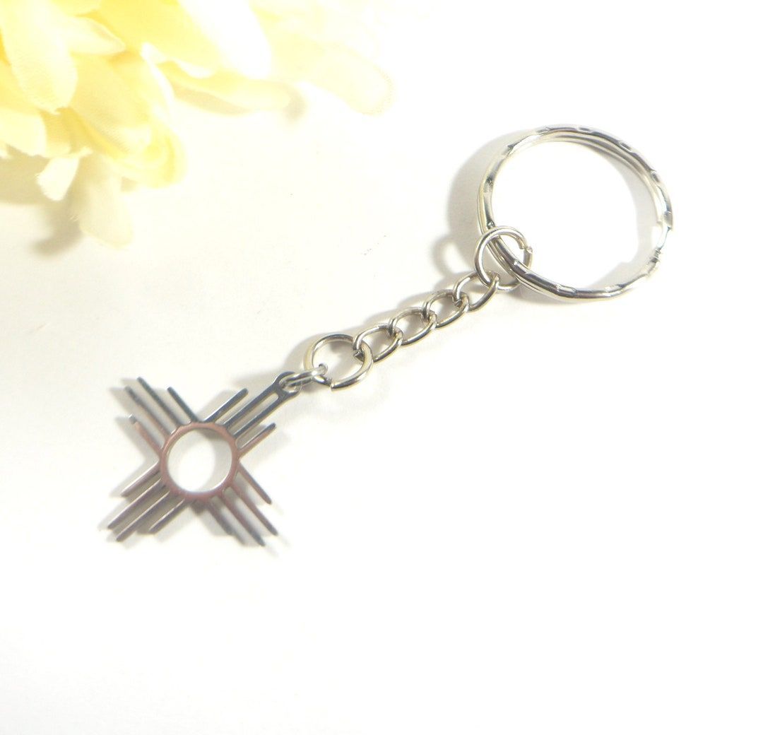 Elevate your everyday essentials with our stainless steel Zia charm keychain. This intricately designed piece pays homage to the rich cultural heritage of the Zia symbol. buff.ly/4aBf1jO #santafe #newmexico  #etsyshop #shopsmall #shophandmade #albuquerque #wiseshopper