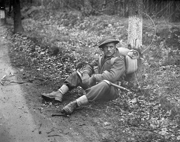 Private N.J. Ingram, Perth Regiment, stops for a rest north of Arnhem, Netherlands, 15 April 1945. Credit: Jack Smith.