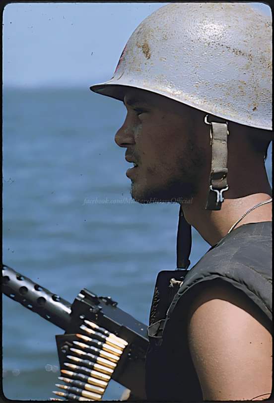 A Navy gunner mans his 50 caliber machine gun on utility boat as it cruises in the Rung Sat zone of South Vietnam during Operation Jackstay., March 26, 1966.