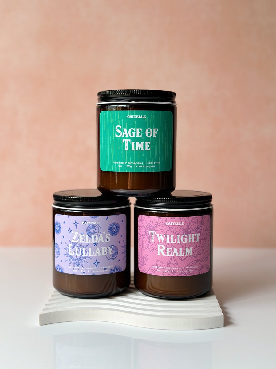 zelda candles scent intro part 2 🕯️✨ sage of time - rosemary, garden mint, herbal sage zelda’s lullaby - lavender, clean linen, light musk twilight realm - violets, white peach, sweet grass, oakmoss