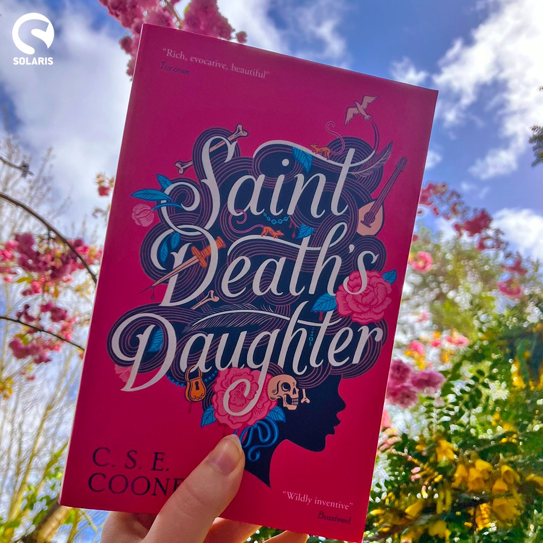 🌸💀 Spring has sprung in the UK & we think Lanie Stones, the world's sweetest necromancer, would approve of us showing off @csecooney's SAINT DEATH'S DAUGHTER with pink cherry blossom, yellow sophora flowers and a blue spring sky! Available to buy now: geni.us/zEYJqx