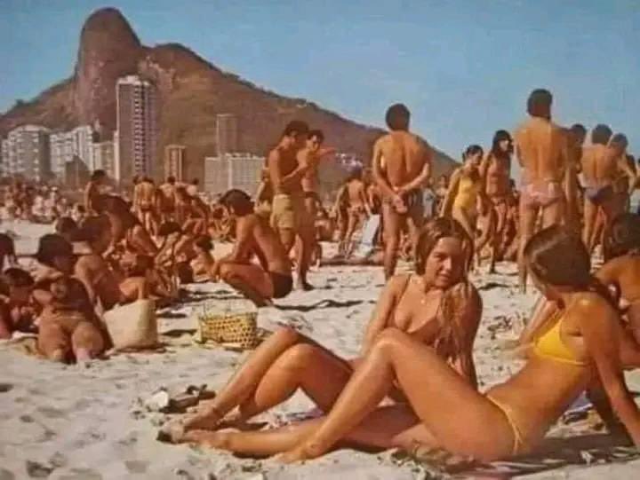 A beach in 1970. No tattoos, no plastic surgery, etc. There are also no beds on the beach, umbrellas, sunglasses, and self-tanning creams...There are no cell phones, so people talk to each other. There is nothing, but there is everything in reality! It was the good old days...