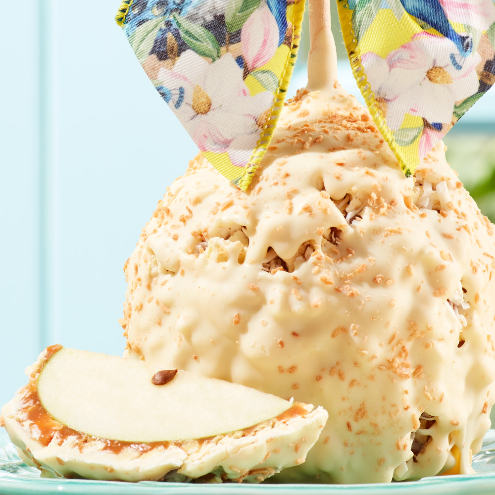 Brighten someone's day with our new Piña Colada Jumbo Caramel Apple, topped with a tropical floral peacock bow. Now 33% off through Thursday! Shop the sale now: bit.ly/MrsPSpring #PinaColada