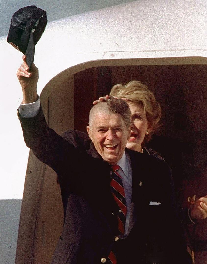 Ronald Reagan taking off his hat after skull surgery with his half shaven head