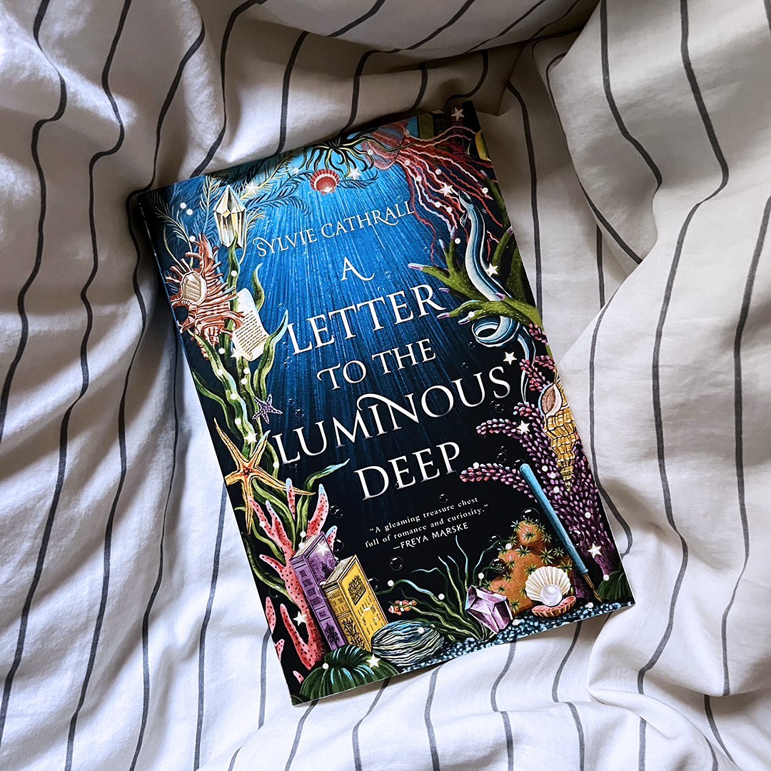 Discover a charming fantasy set in an underwater world with magical academia and a heartwarming penpal romance. A LETTER TO THE LUMINOUS DEEP by @SylvieCathrall is coming next week!