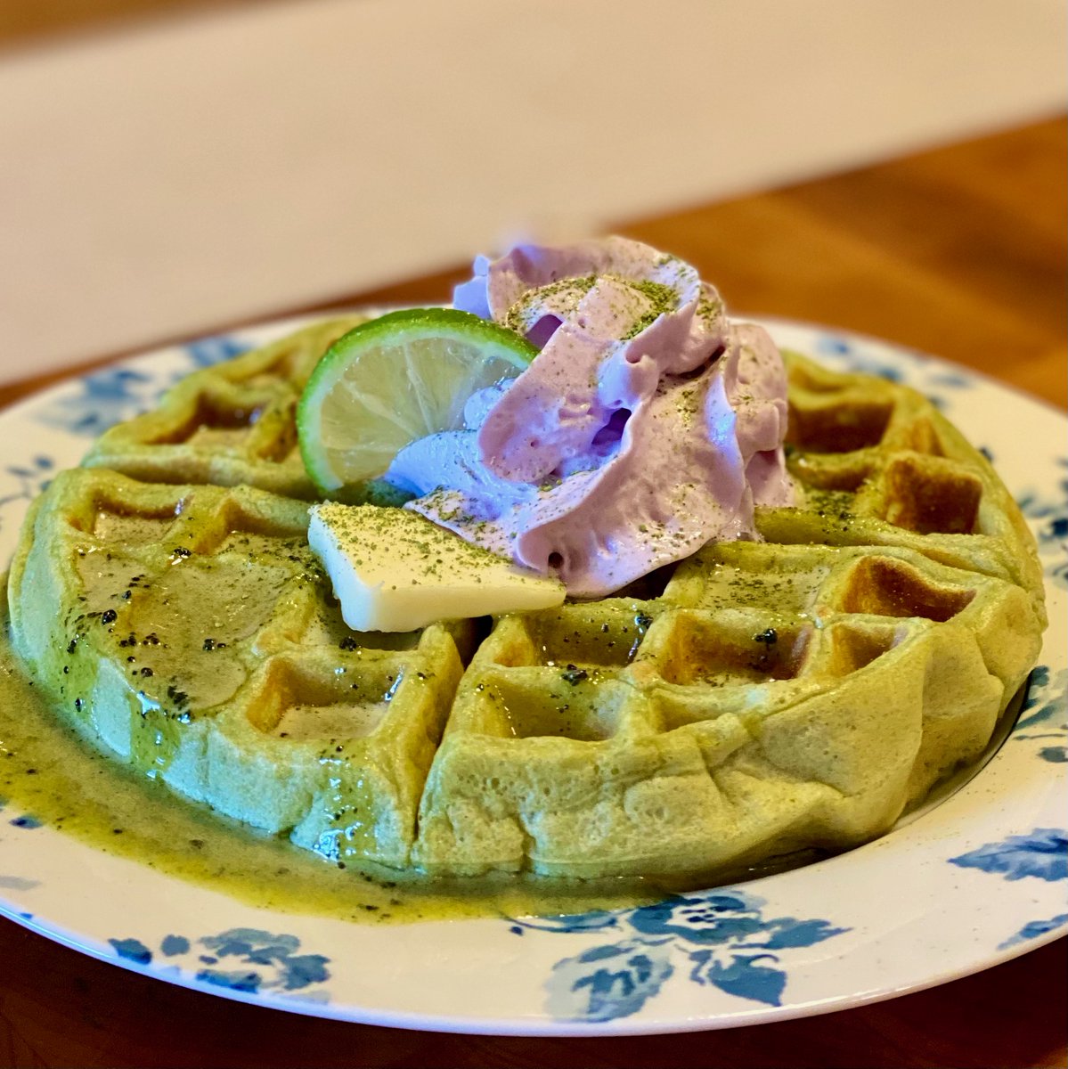 Tonight for breakfast-for-dinner, I made 'Perfect Note Waffles' from Sonic the Hedgehog: The Official Cookbook. They're matcha waffles served with a lime-matcha curd and some lavender whipped cream.