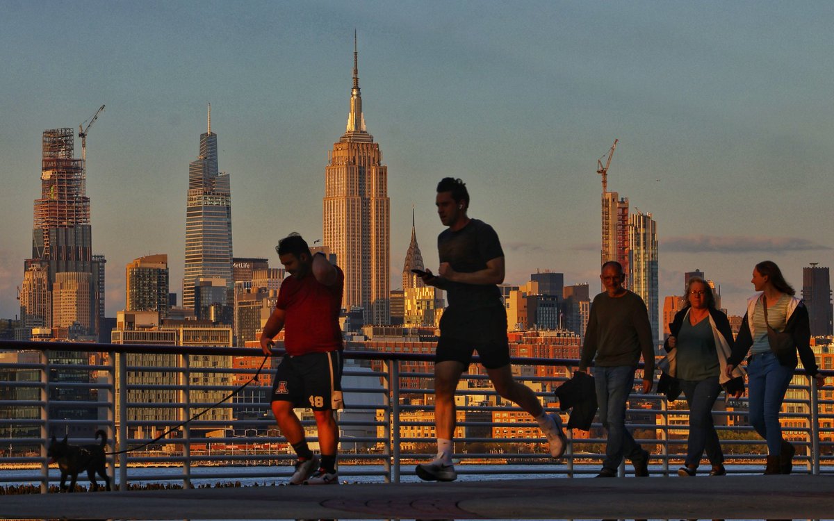 Sunset on a beautiful spring day in New York City as people walk along the Hudson River in front of the Empire State Building, Monday evening #NYC #newyork #newyorkcity #sunset @empirestatebldg