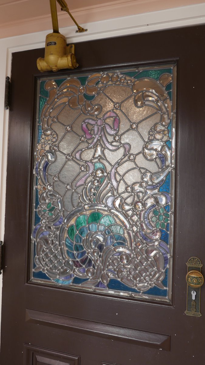 EDL Glass. Doors to 'Walt's Restaurant' 1992. Sparkling clear beveled 'leaded' glass (w jewels) can be complex and elegant yet appear restrained. 'Clothiers' back door takes the same approach with a dose of color.