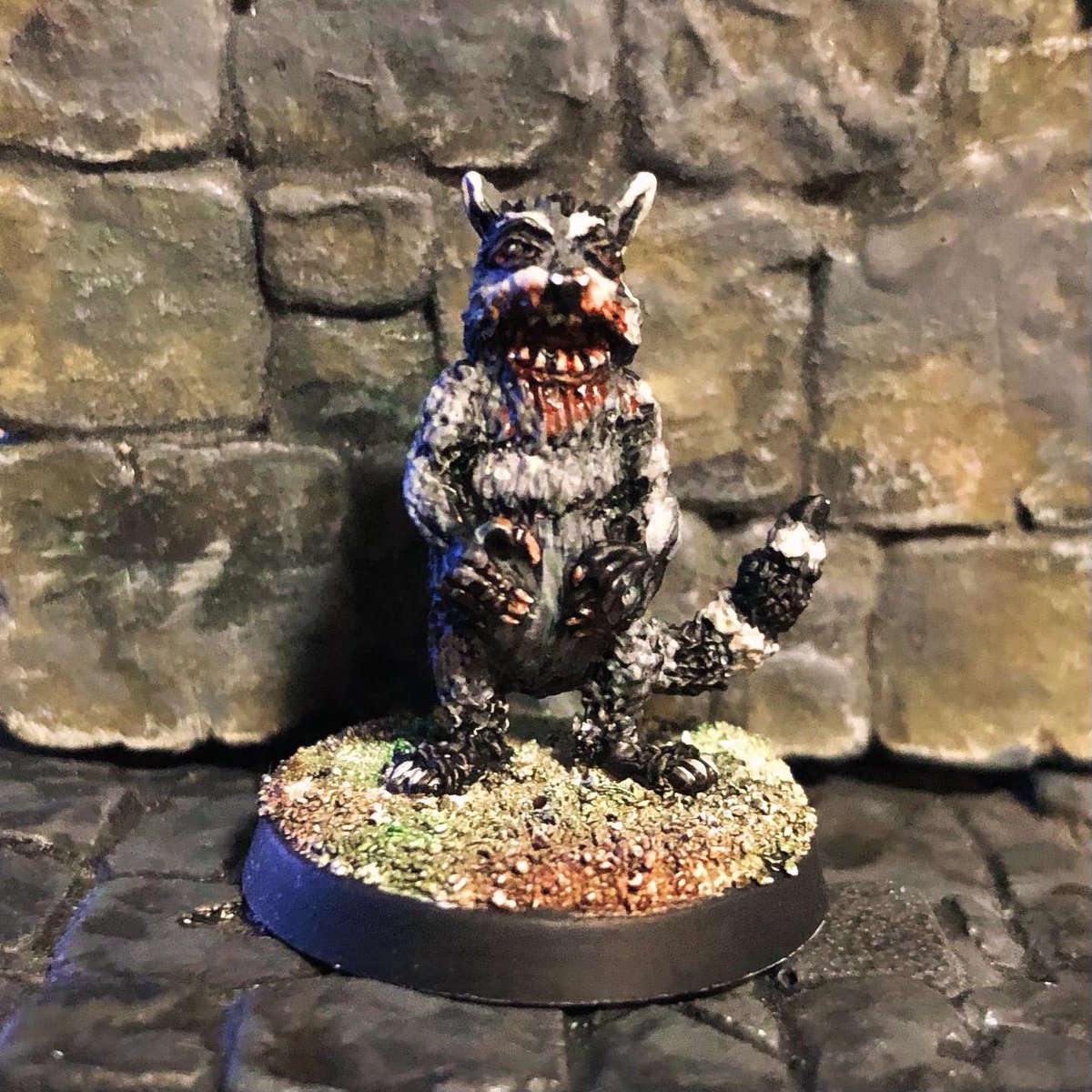 Look at this lil’ guy! He’s a Grim Raccoon, sculpted by <a href="/beQuestMinis/">beQuest Miniatures</a> , painted by Kim Washburn

You’ll be seeing more of him soon!