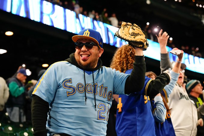 Mariners fan cheering in stands.