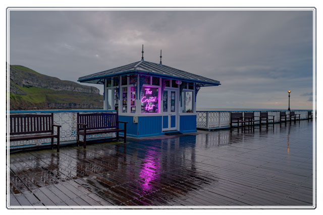 There are many #smallbusinessowners who operate #shops on #Llandudno #pier @PierLlandudno in #NorthWales. A #storm may have reduced #customer numbers, but the #rain highlights the #reflections of the #crystal #shops #neon. #Cymru #landscape #photography #Wales @KrisCMeredith