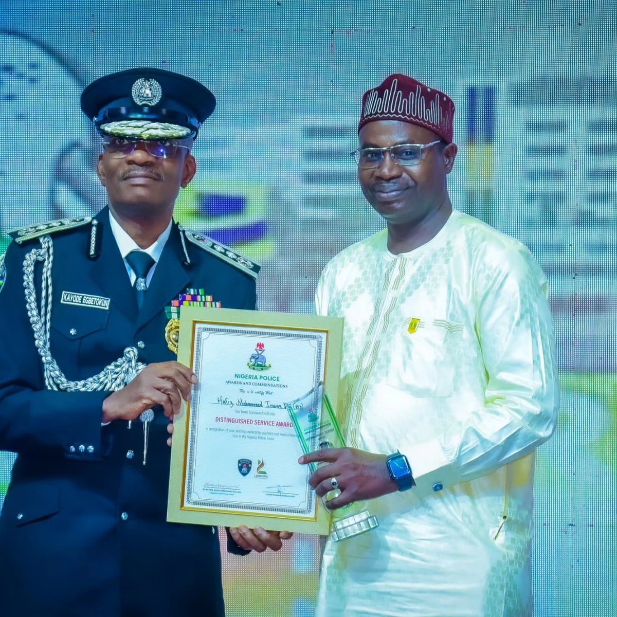 IGP Kayode Adeolu Egbetokun, Ph.D, NPM, presents an award of distinguished service to DIG Hafiz M Inuwa, mni, former DIG DTD and former Force Secretary, on monday in abuja.