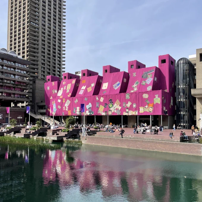 The exterior of the Barbican Centre wrapped in purple fabric