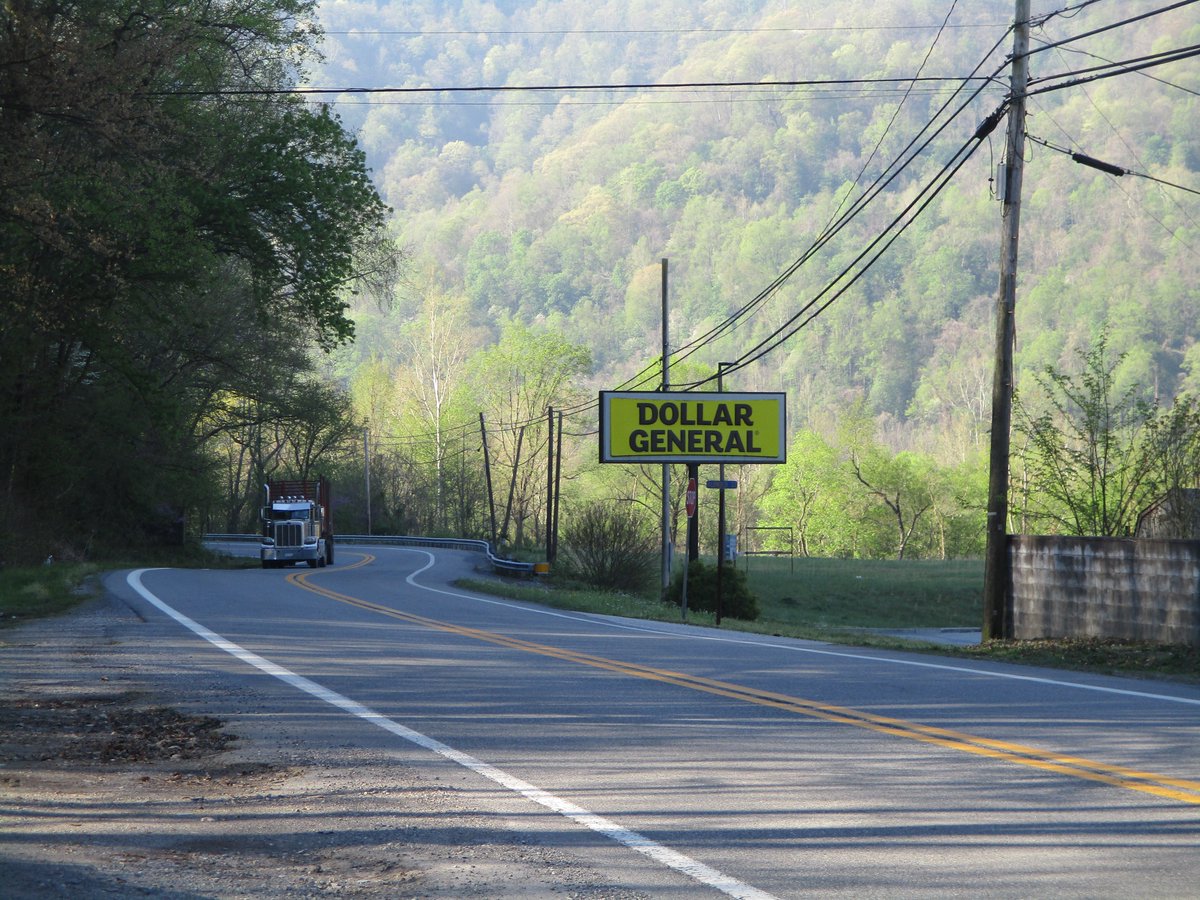 logging truck passes a Dollar General in West Virginia