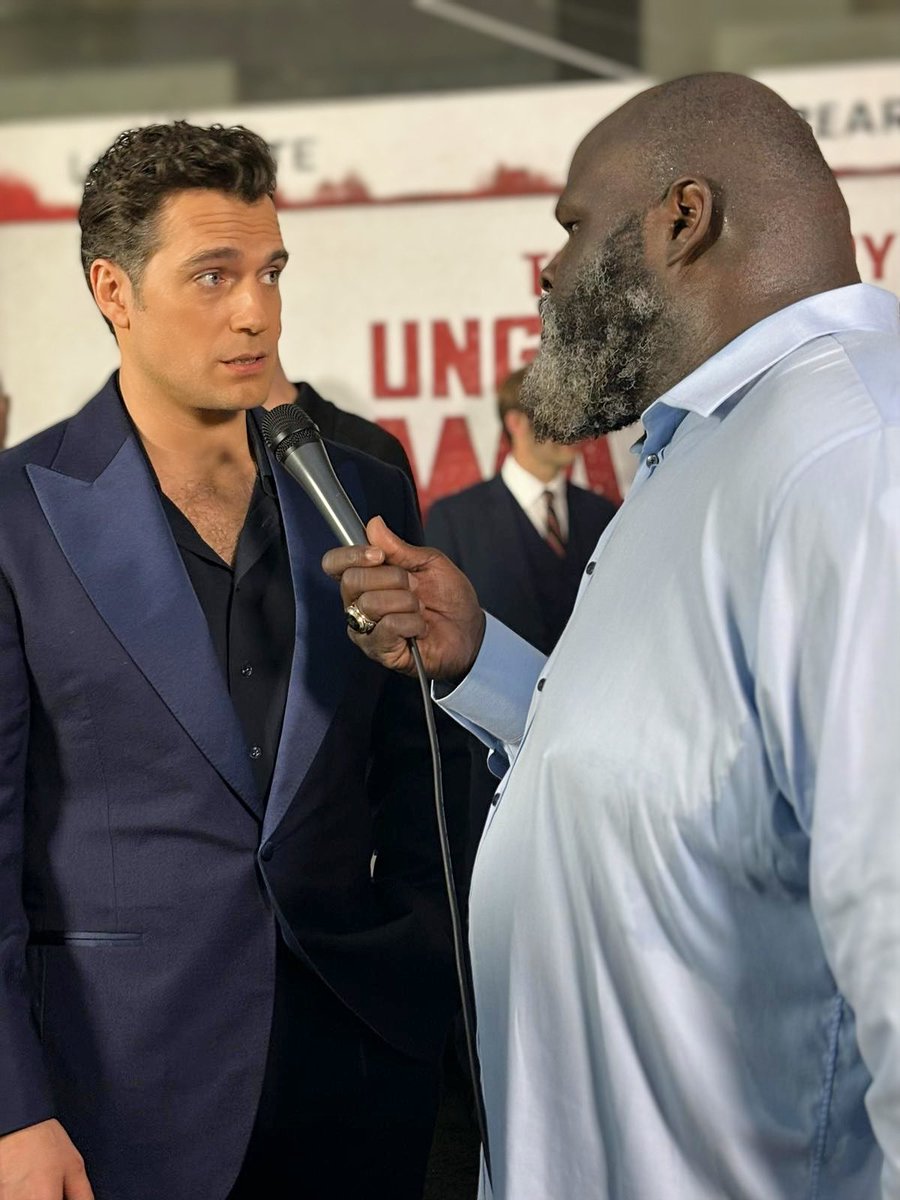 TheMarkHenry's tweet photo. Caption Contest Alert! 🚨 Mark Henry interviews Henry Cavill on the black carpet in NYC for @Lionsgate’s new release, ‘The Ministry of Ungentlemanly Warfare.’ #UngentlemanlyWarfare What do you think Henry Cavill was thinking the moment the Man of Steel met the World’s Strongest Man? Best caption scores a remarkable T-shirt and autograph from Mark Henry himself! Let the creativity flow! #TheMarkHenryShow #WorldsStrongestInterviewer