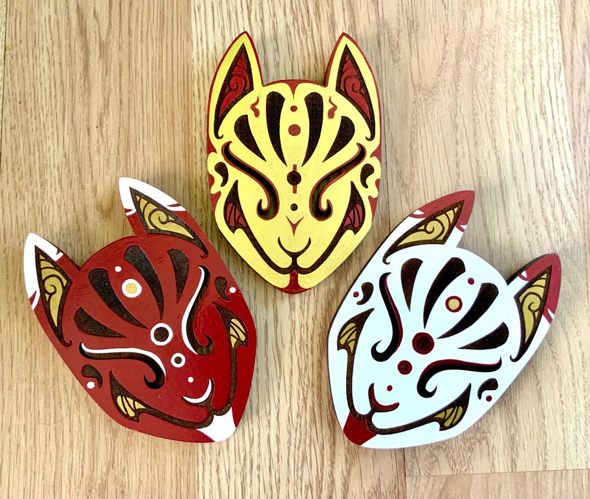 I made some large painted kitsune mask designs. These are 5.5 inches tall with wall hanging hardware screwed into the back so they can be hung up. I am adapting a handful of my designs into wall decor like these