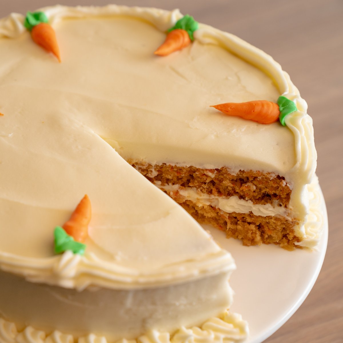 Frosting carrots are like snowflakes, every one is unique, because they're piped on by our bakers every day!