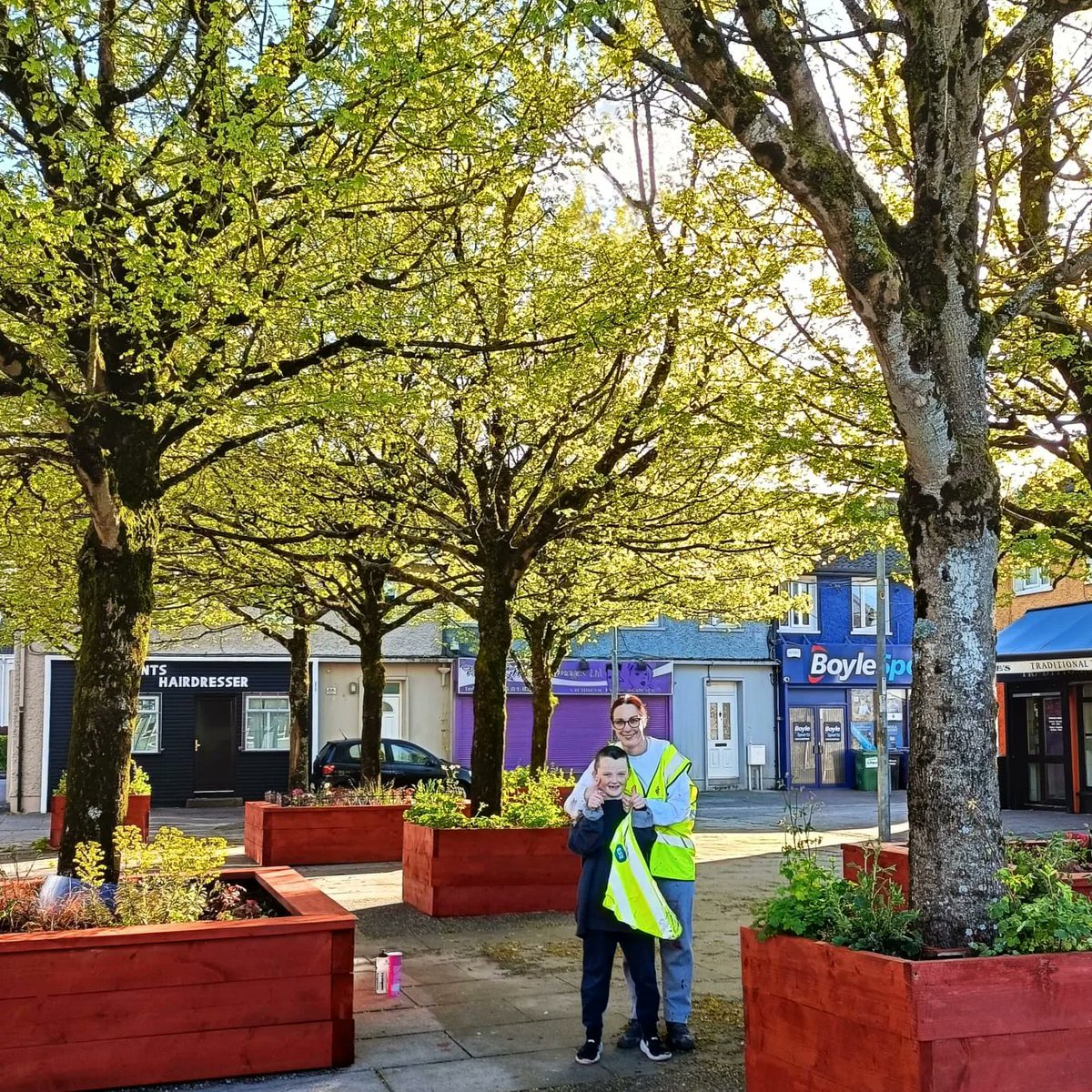 We are in full swing prepping for our Cherry Blossom Festival this weekend.🌸🦺
 Tonight the dream team of Natalie ,Konrad and of course the little boss man Alex sanded and painted the planters in Pearse Square. 

#ballyphehane 
#TidyTowns
#LoveYourHane