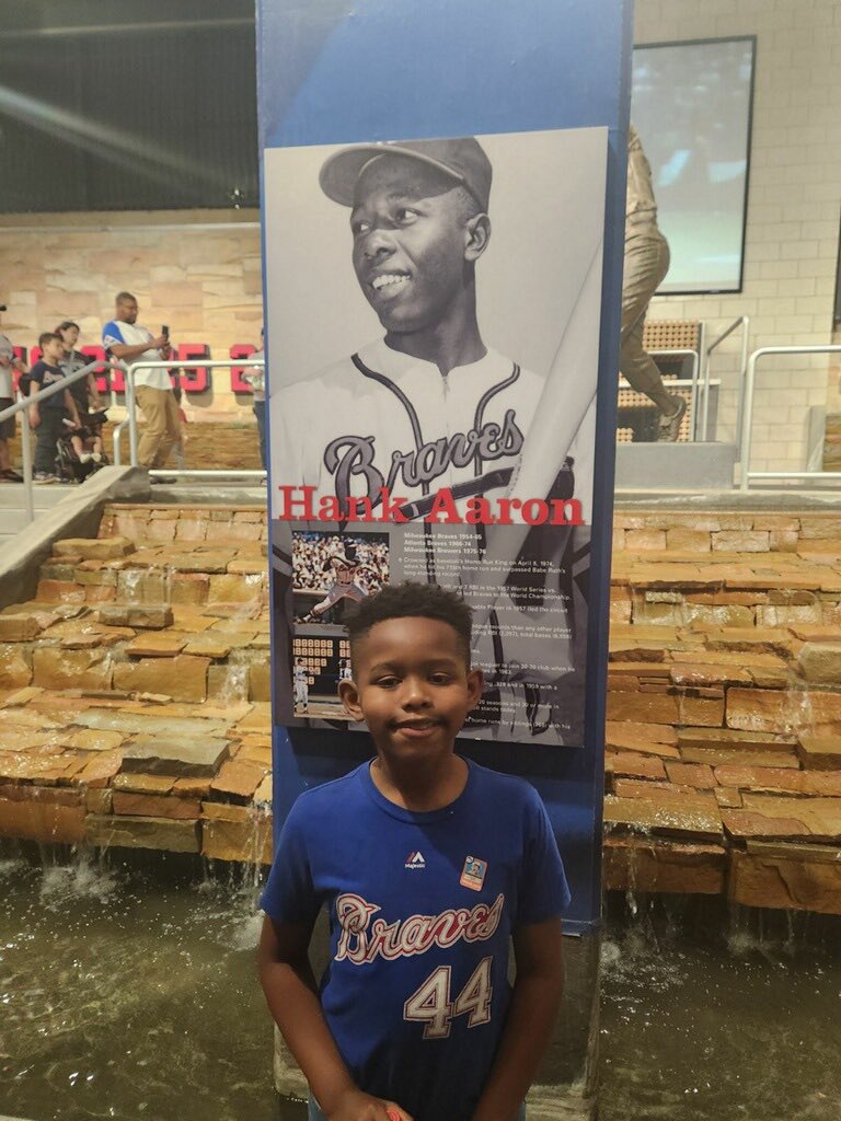 In this baseball season, which commemorates the 50th Anniversary of Hank Aaron's 715th homerun, it is only fitting that my grandson, Aaron, and his dad stand with him. Hank Aaron was #44. Our Aaron was born at 3:44 and delivered by Jackie Robinson! What more can I say!