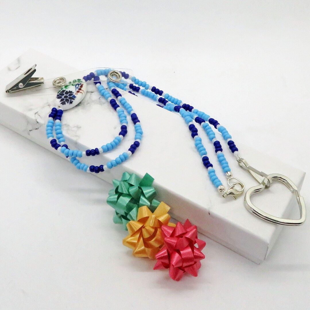 Blue Flower Glass Seed Bead Heart Key Ring ID Badge Lanyard Holder from RivendellRocksSedona. Handmade in the USA, this small business offers unique accessories. #HandmadeAccessories #SupportLocalBusinesses buff.ly/47Mv38O