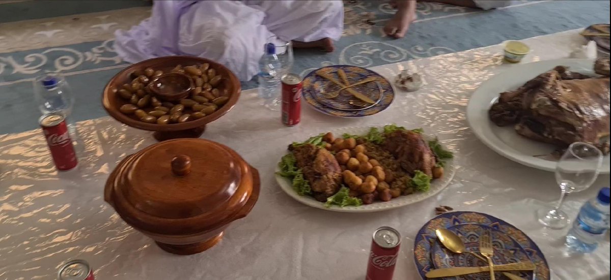 Lunch is served. An impressive smorgasbord of food, prepared by our friend at his house in Nouakchott, Mauritania. The main dish is barbeque lamb. We are also served with chicken, potatoes, and olives.