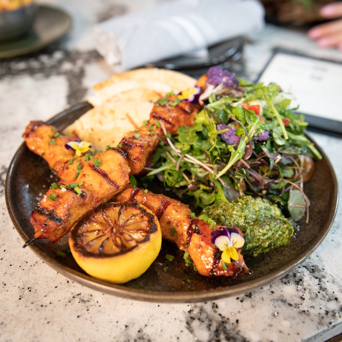 Chicken Skewers packed with flavor... Honey orange tajin glaze, roasted cauliflower & cherry tomato arugula salad, cilantro pecan pesto, guajillo-ancho chile dry salsa. #ItStartsHere londonhousechicago.com/rooftop/