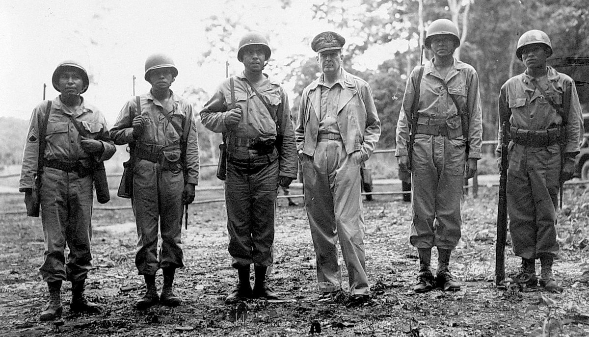 General Douglas MacArthur meeting with five Native American troops from different tribes serving in the same unit during an inspection trip of American battle fronts in the South Pacific, 1943. #History #WWII