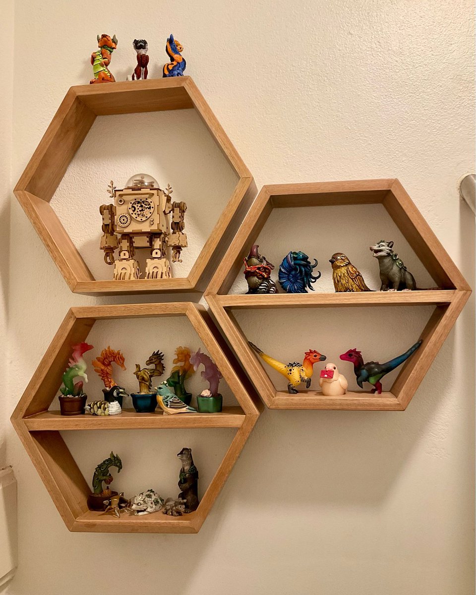 Completed hexagon shelves. These are now securely hung in my stairwell & host about half of my figurines made by @verdantsculpts, plus a few other random sculpts.