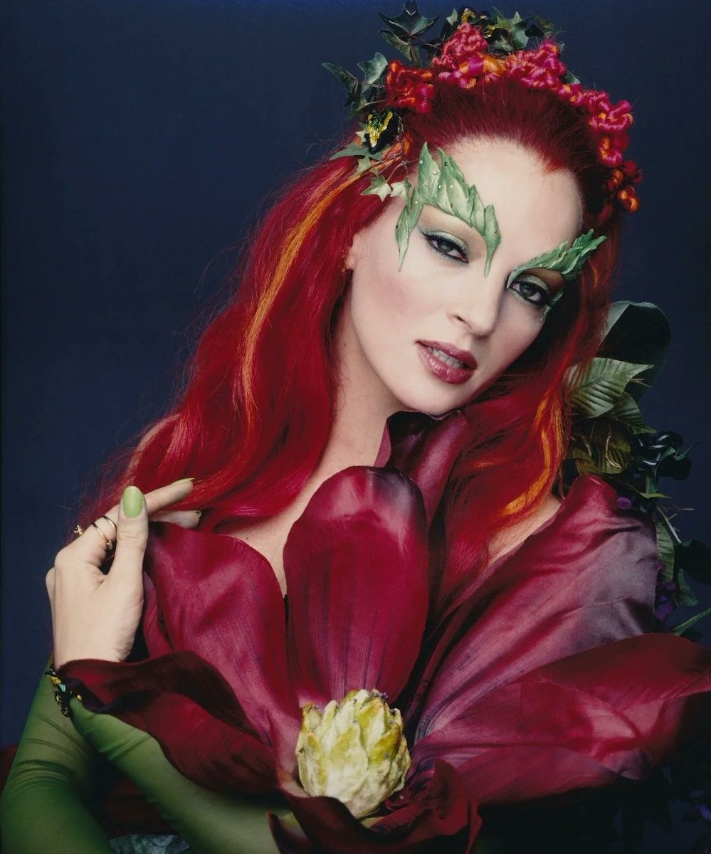 Promotional/Publicity Photo of Uma Thurman as Poison Ivy (in her first costume) from Batman & Robin, posing with a big flower and looking absolutely stunning here. Her first costume is still probably my favorite of her 3 outfits.