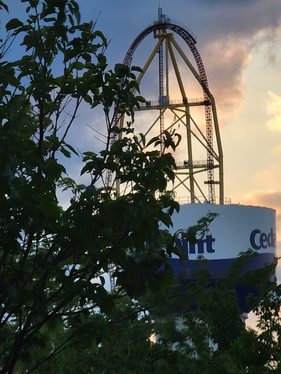 Cool_Coasters's tweet photo. Top Thrill Dragster above the Cedar Point water tower beyond the trees as seen from the Boardwalk with a sunset shrouded in clouds. 18 days until we experience Top Thrill 2. #CedarPoint #TrainlessTuesday 
#CoolCoastersAndSunsets 😎🎢😍
#CoolCoasters #TopThrill2 #ForFamilyAndFun https://t.co/aZUOifcaS7