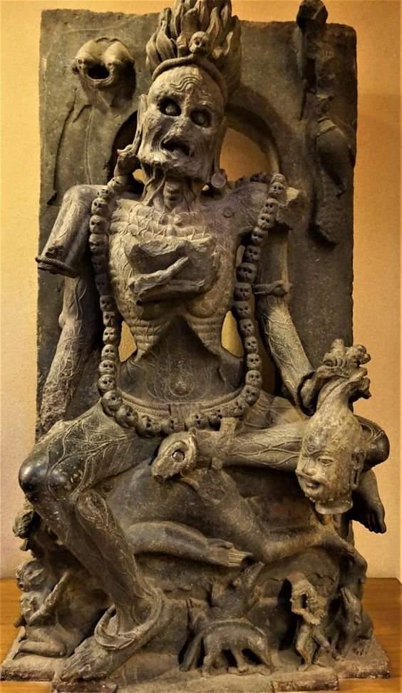 A 8th Century AD, Statue of Chamundi - Terrifying manifestation of  Kali; a fiery representation of Shakti (female energy), from Jajpur, Odisha, India. 

Statue adorned with a garland of skulls, her jatamukut (crown if thorns) tied with a snake, and a bowl of blood in her hand.