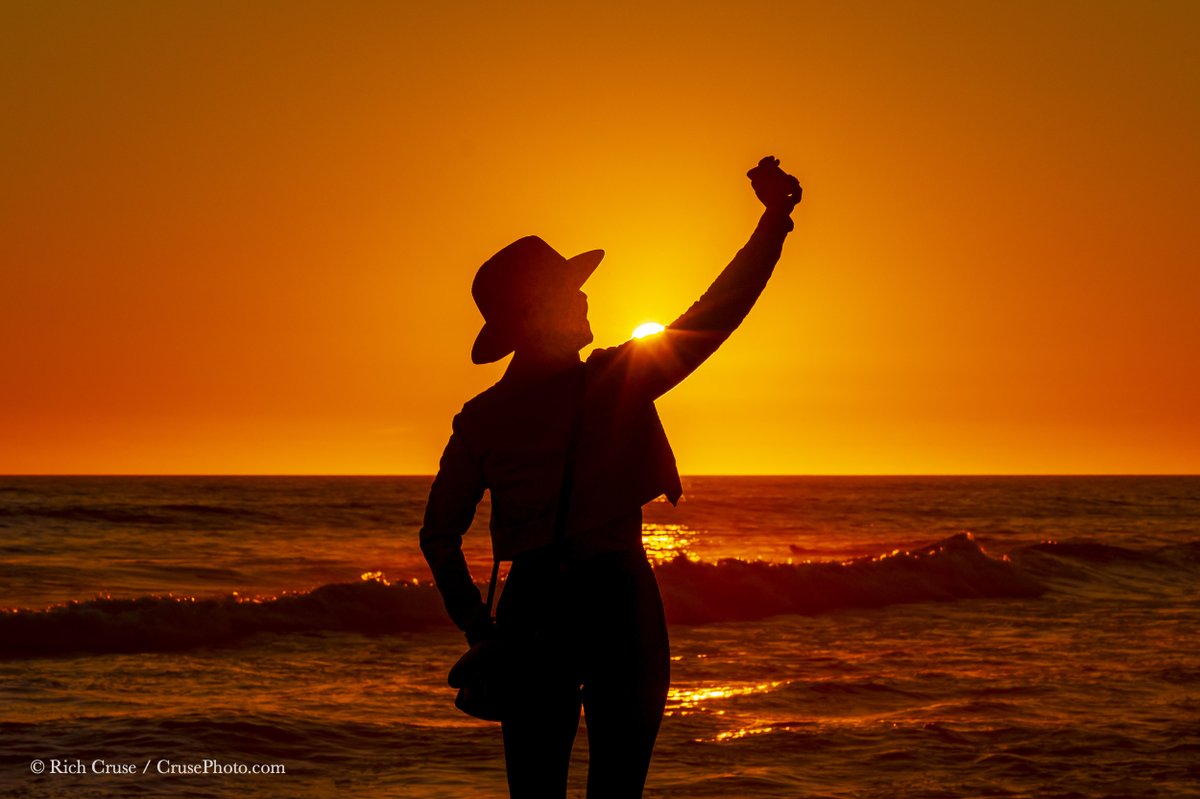 A woman takes a selfie at #sunset in South #Oceanside. April 16, 2024 @VisitOceanside @visitsandiego @VisitCA #StormHour #ThePhotoHour #CAwx #SanDiegoWX @NikonUSA