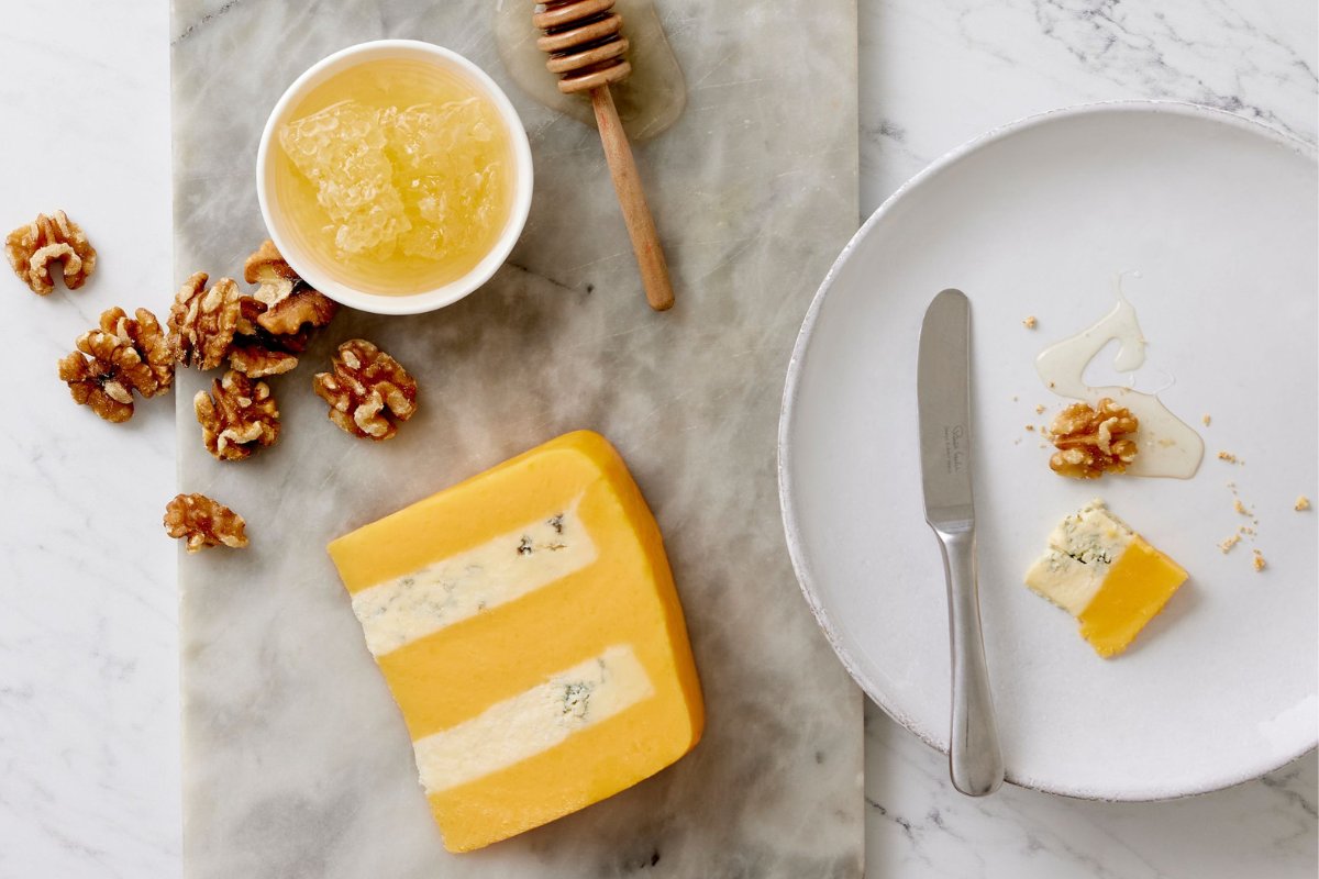 Huntsman is available to order in 4.4lb half moons! Double Gloucester and Blue Stilton are layered together to produce a firm and smooth, nutty cheese with a contrasting tang of the creamy blue cheese. Find out more: coombecastle.com/product/huntsm…