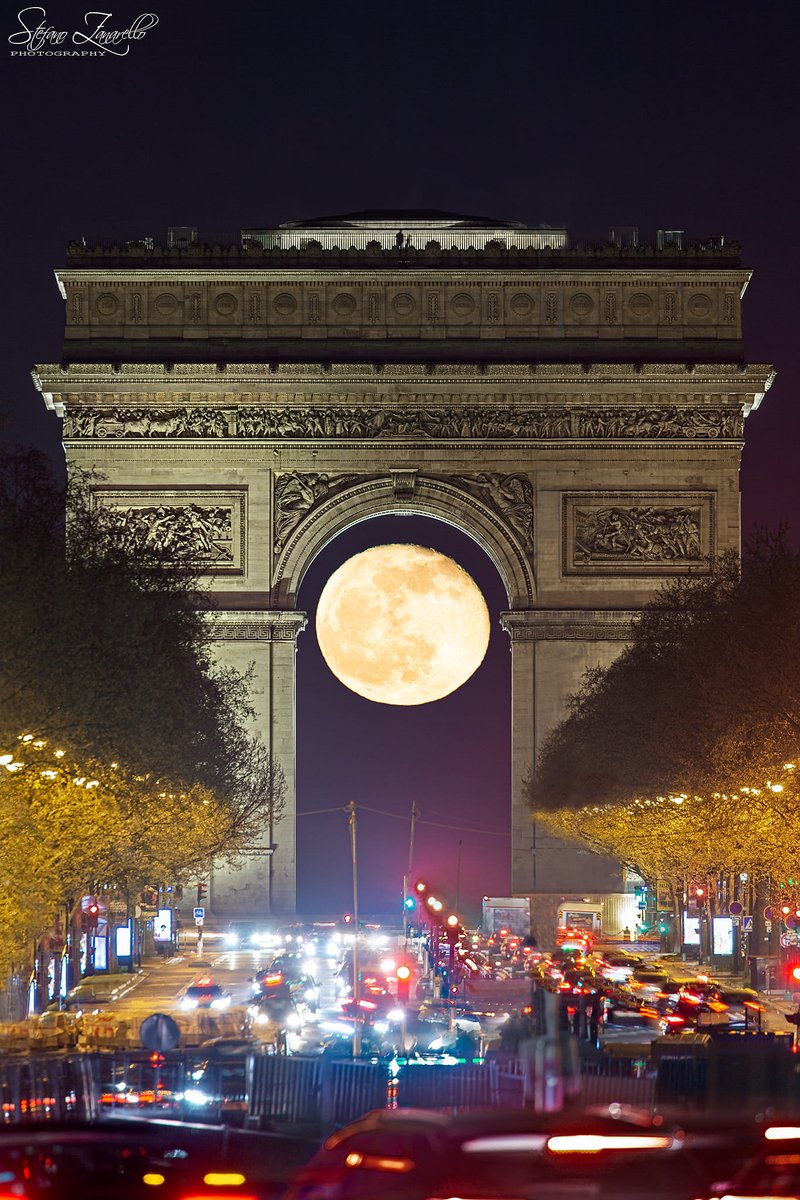 6. Paris's Arc de Triomphe perfectly frames a glowing full Moon by Stefano Zanarello