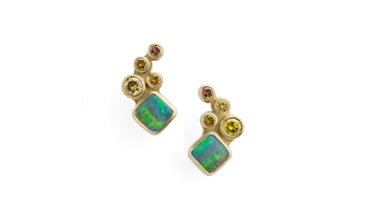 We're a bit obsessed with opals and these beautiful 18ct gold earrings are no exception. The gorgeous greens and blues of the opals remind us of holidays by the ocean, whist the stunning champagne and cognac diamonds tumble like a waterfall meets the sea. Stunning!