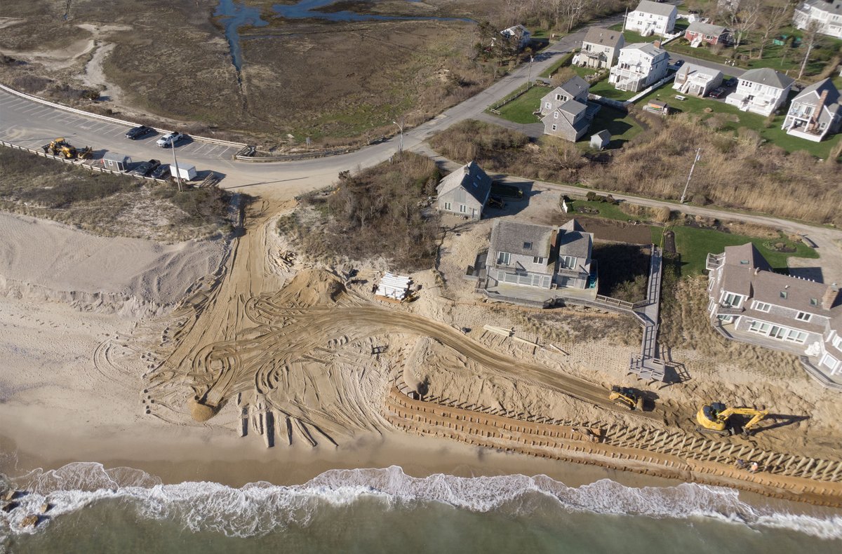Sand on the move at Town Neck Beach in Sandwich where private homes at right bring in more to fortify and the public beach at left is closed to the water after high winds and tides have chewed away the recently reconstructed dune. @capecodtimes