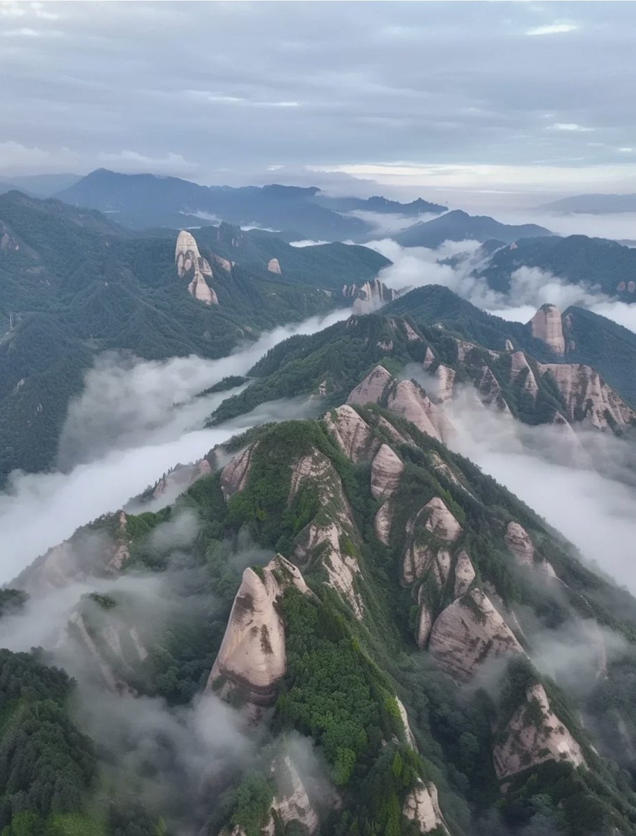 Behold a stunning aerial view of fog-shrouded peaks in Langshan #Mountain in #Hunan, one of China's six #Danxia landforms collectively enlisted as a UNESCO World Natural #Heritage site. (Photo Credit: Gx)