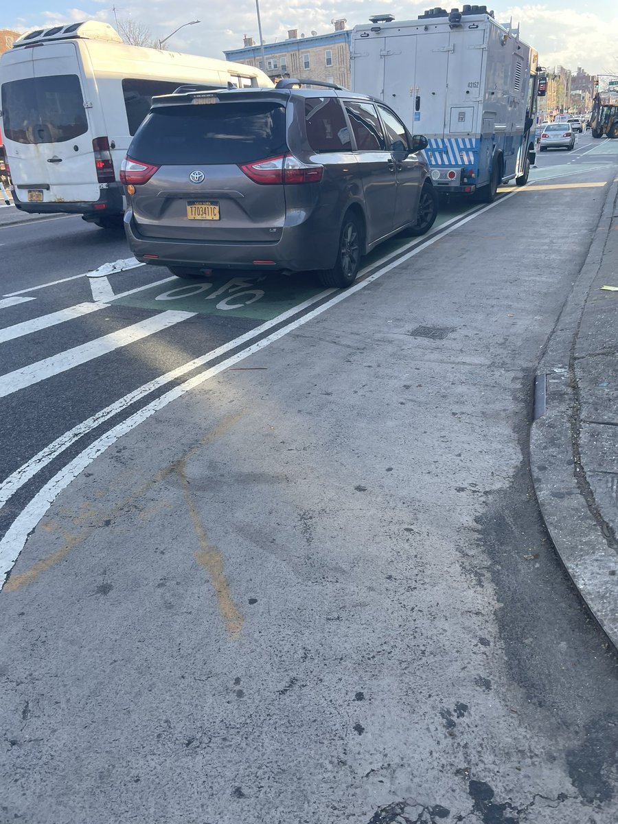 BikeSouthBklyn's tweet photo. The Fourth Ave. bike lane is perpetually blocked outside entrances to the subway, like it is here at 25th St.

This design isn’t working (and never has) but @NYC_DOT isn’t planning  to address it until the 2030s. #Fix4thAve https://t.co/Qi4ofJ7Otn