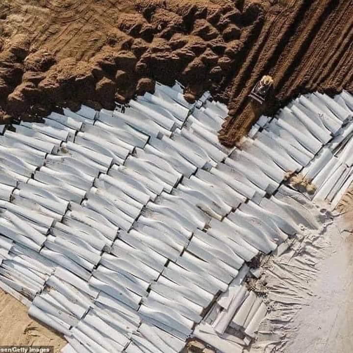 That little yellow thing is a bulldozer. It is burying windmill blades used for green energy. Why? Because these blades need to be disposed of and there is presently little effort made to recyle them. That’s how green energy works! - Credit Unknown